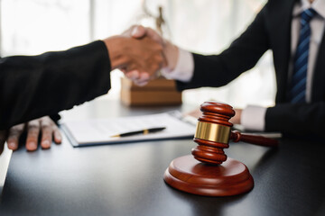 Handshake after consultation between a male lawyer and client, a lawyer is currently counseling the client's trial at the lawyer's office.