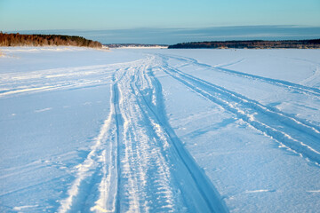 Traces of vehicles and people on the frozen and snow-covered Volga River