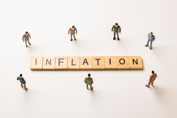 businessman figures at inflation words