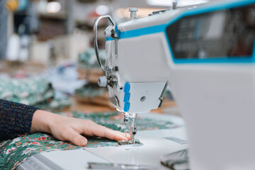 Concept Interior of garment factory. Closeup spool of multicolored threads for sewing machine