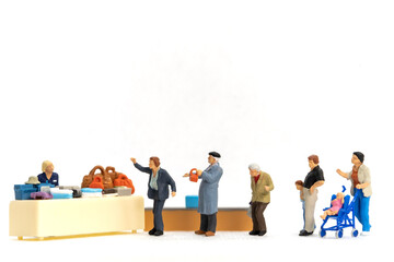 Miniature people Shoppers with discount tray for shopping discounted items on white background