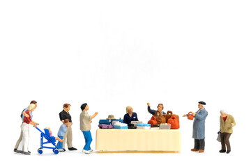 Miniature people Shoppers with discount tray for shopping discounted items on white background