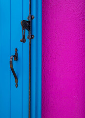 old door handle, blue wood door and pink wall