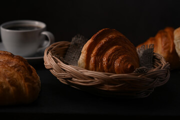 Homemade butter croissants in wicker basket ready to serve for breakfast. Breakfast, bread bakery products cafe concept