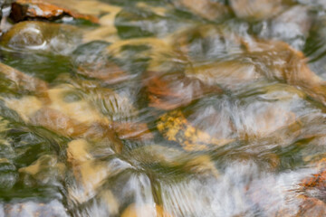 Water flows over the cobblestones. Texture