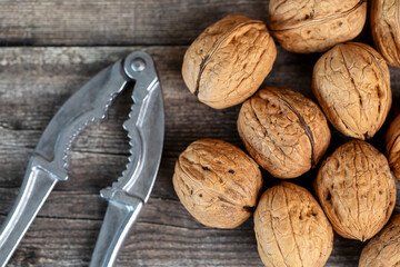 walnuts and nutcracker on wooden table