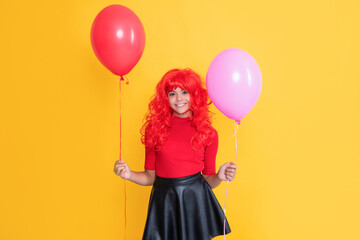 smiling teen kid with party balloon on yellow background