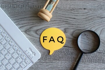 Hourglass, magnifying glass, keyboard and text FAQ. Frequently asked question concept
