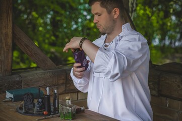 Man wizard with magical stuff. Halloween concept, masquerade or cosplay Medieval men's look