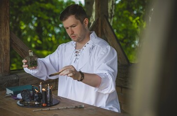 Man wizard with magical stuff. Halloween concept, masquerade or cosplay Medieval men's look