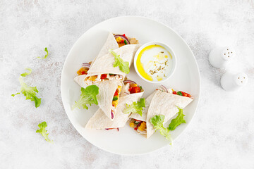 Greek chicken wraps souvlaki with vegetables and tzatziki sause. Top view