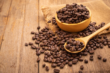 Coffee bean on wooden table background. Food and beverage concept