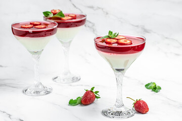 Italian panna cotta dessert with strawberry and mint on a light background. Summer yogurt dessert. space for text