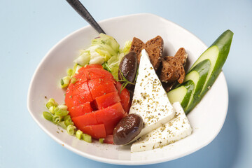 Greek salad, feta cheese with vegetabls and toast bread 
