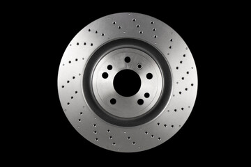 Car brake disc isolated on black background. Auto spare parts. Perforated brake disc rotor isolated...
