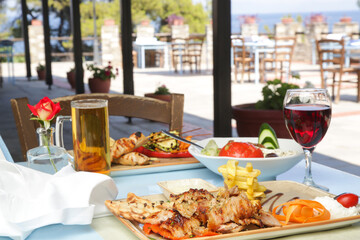 Greek dishes served with drinks on the restaurant table