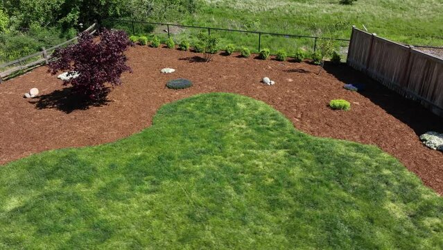 Aerial of a fresh bed of bark in a landscaped backyard.