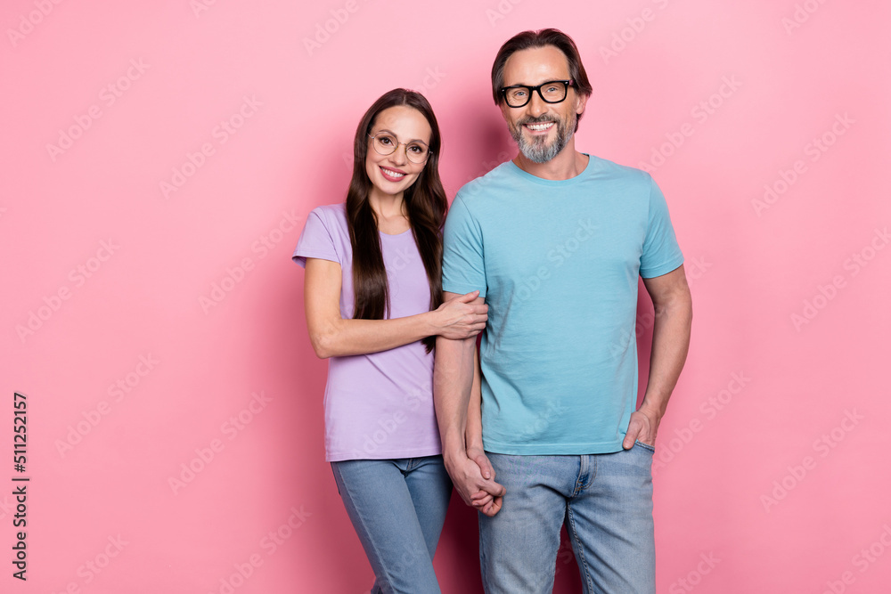 Sticker Portrait of charming lady handsome man hold arms toothy smile isolated on pink color background