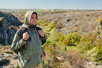 Hiker young man with backpack at the mountains