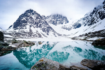 Views of the Lyngen Alps already snowy. Blavatnet - the norwegian glacial Blue Lake in Northern...