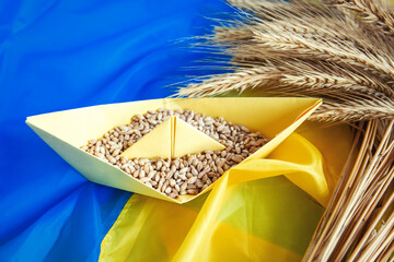 grain wheat and spikelets on a blue background. Ukrainian grain and problems of sea blockade of...