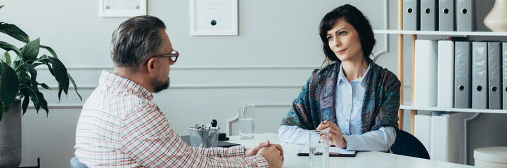 Middle age elegant female boss during job interview with senior