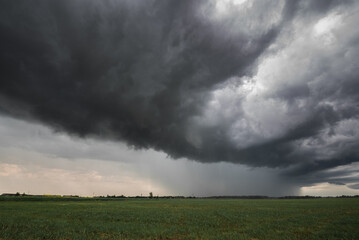 Naklejka na ściany i meble Storm clouds in the fields. Weather forecast photo for thunder and rain