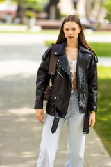 Fototapeta premium Attractive young woman enjoying her time outside in park