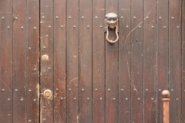 door with knocker in taormina in sicily (italy)