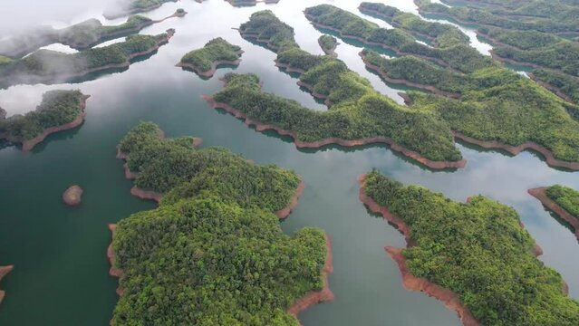 Ta Dung lake seen from above in the morning with small islands of paradise with beautiful abstract shapes. This is the reservoir for increase in Dac Nong, Vietnam.