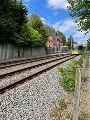 Close up of a moving tram going past through Didsbury in Manchester England. Metrolink tram.