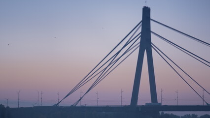 Silhouette bridge tower tranquil evening cityscape. City bridge on sunrise sky