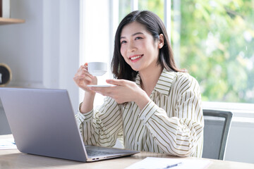 Image of young Asian business woman working at office