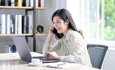 Obraz premium Image of young Asian business woman working at office