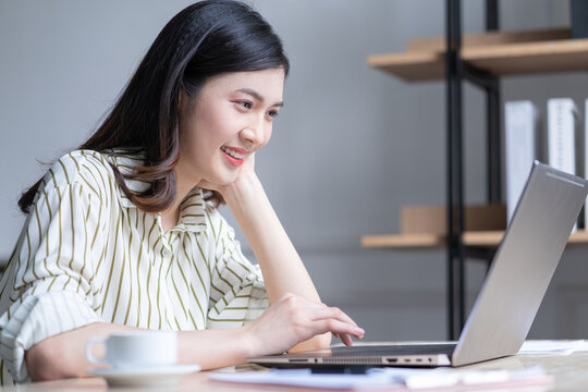 Image of young Asian business woman working at office