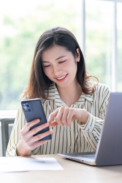 Image of young Asian business woman working at office