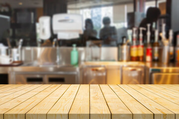 Empty wood table top with coffee shop cafe restaurant counter blur background