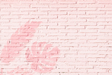Panoramic background of wide old pastel pink brick wall texture with palm tree shadows. Modern trend backdrop