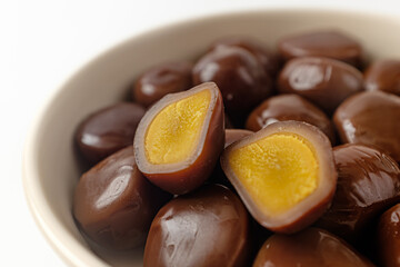 smoked quail eggs on a white background