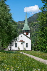 Fototapeta na wymiar Old church and spring blooming at Lauterbrunnen. Switzerland.
