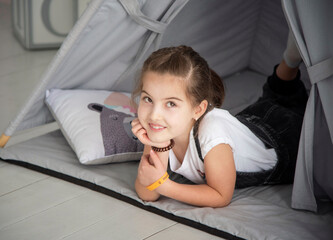 little girl playing in a toy wigwam © Tetatet