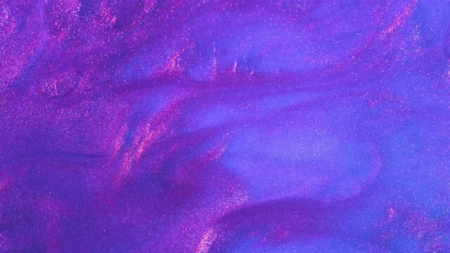 Liquid background video with purple and pink glitters. Abstract sparkle backdrop with particles in motion. Footage with flow twinkling sparkles. Colorful and vivid fluent animation.
