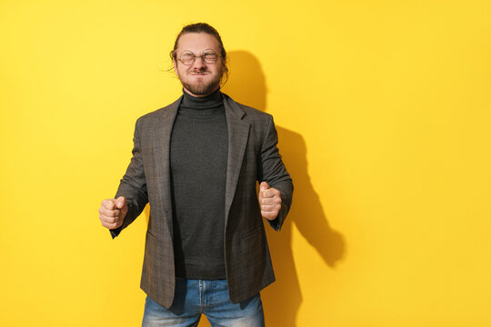 Man Making Silly Face Against Yellow Background