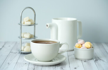 Fototapeta na wymiar Green tea, Sweets, teapot, milk, on a white background