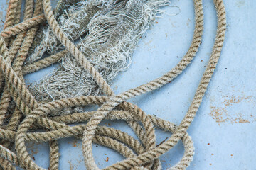 Closeup of coil of nautical rope on fishing boat hull.
