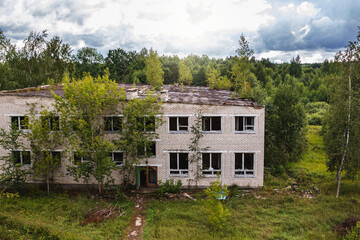 Fototapeta na wymiar Exterior of abandoned apartment building in european ghost town.