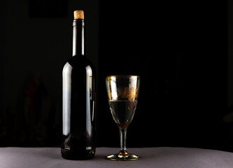 bottle of wine and glasses on a black background