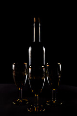 bottle of wine and glasses on a black background