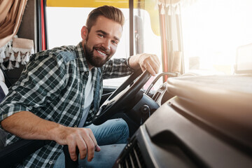 Young and happy smiling truck driver inside his vehicle © blackday