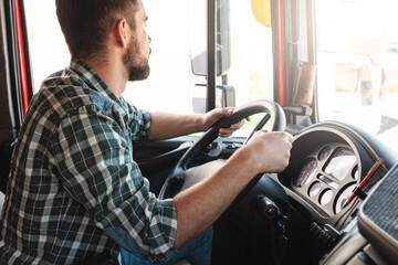 Male truck driver driving his big vehicle